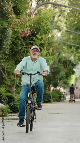 Happy active hispanic senior man doing healthy exercise riding bicycle in the city