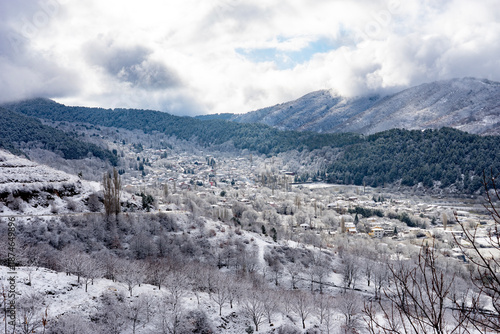 Bozdag village nestled in snowy mountain valley landscape.