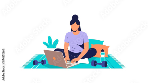 Woman working from home on laptop with yoga mat and dumbbells