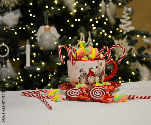beautiful New Year's Eve cup with marshmallow marshmallows and candy canes. sweet treat for children and adults. celebration of new year and christmas. gift under the tree