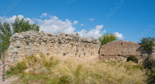 Ancient Brick Ruins in a Sunny Field, Surrounded by Wild Grass and Nature