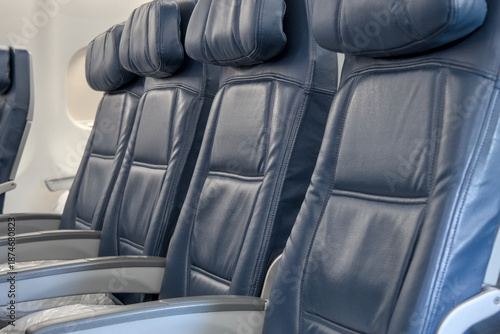 Obraz na płótnie blue empty seats on airplane during takeoff landing (flying plane travel tourism
