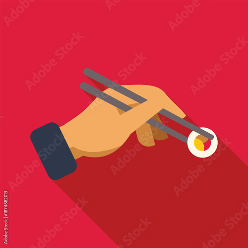 Hand holding a maki sushi roll with chopsticks on a red background