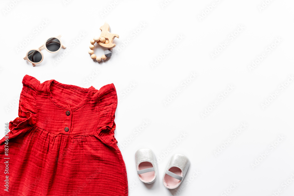 Φωτογραφία Flat lay of summer clothes for girl - red cotton muslin dress with shoes and acc