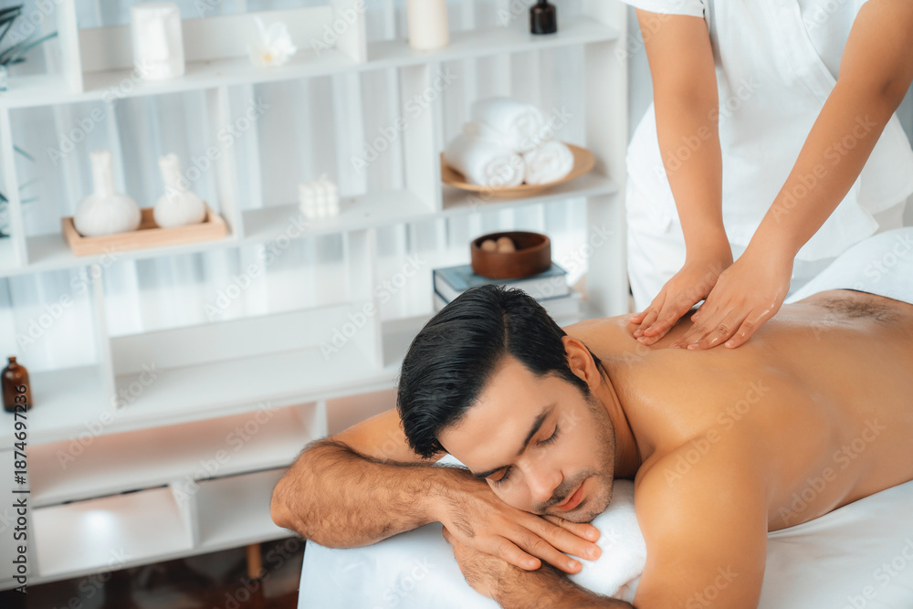 © InfiniteFlow - Caucasian man customer enjoying relaxing anti-stress spa massage and pampering with beauty skin recreation leisure in day light ambient salon spa at luxury resort or hotel. Quiescent © InfiniteFlow - Caucasian man customer enjoying relaxing anti-stress spa massage and pampering with beauty skin recreation leisure in day light ambient salon spa at luxury resort or hotel. Quiescent