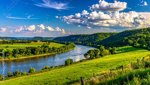 Wallpaper Mural Scenic landscape featuring a winding river cutting through lush green hills under a bright blue sky filled with puffy white clouds Torontodigital.ca