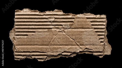 Torn and cracked brown cardboard fragment with corrugated texture on black background close up studio shot