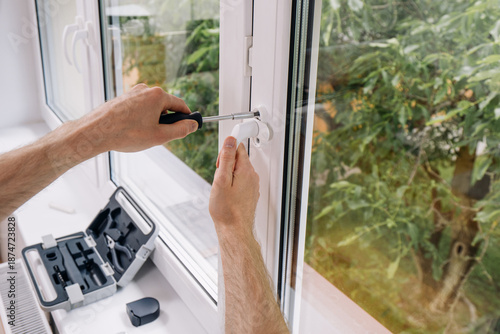 Quadro su tela Repairman installing double glazed PVC window frame in a residential space