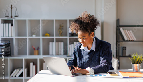 Photos Business in afro hair bookkeeper working with financial report in in office