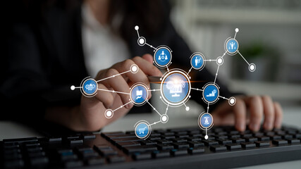 A business professional engages with a computer keyboard, highlighted by digital icons that symbolize technology, connections, and innovative solutions in a modern office. Tessel