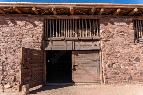 Hubbell Trading Post National Historic Site in Arizona. Historic Barn built with sandstone blocks and ponderosa pine. Used to stable horses and mules   for freighting business. Hay loft and barn doors