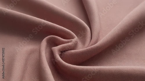 Soft fabric swirling in a gentle spiral motion, showcasing texture and gentle folds in a serene atmosphere