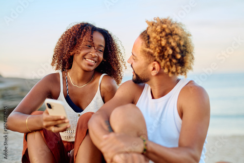 Bilde på lerret Happy couple spending time together on vacation, smiling and laughing while look