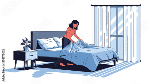 Woman making her bed in a modern bedroom with blue tones