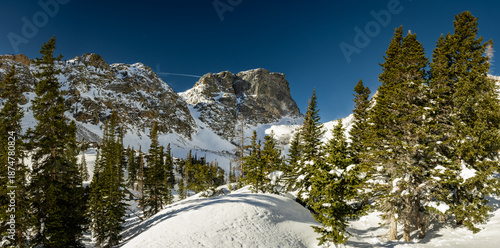 Canvas Print Hallett Peak Rises Over Snow Covered Forest And Emerald Lake In Rocky Mountain