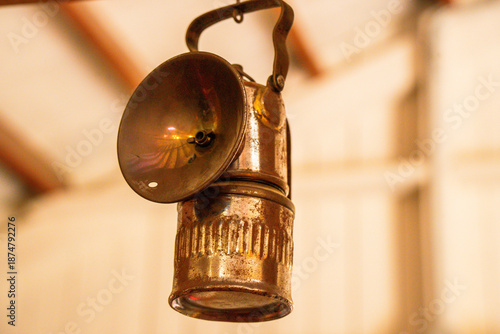 Historic metal mining lamp used for underground illumination
