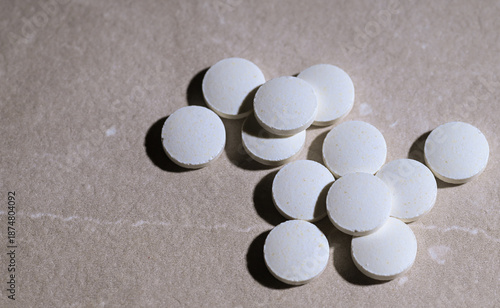 Close up of White weight Loss Pills on Stone Countertop