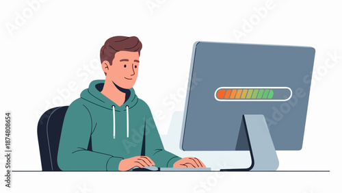Young man in teal hoodie working on a computer with a colorful progress bar on the screen