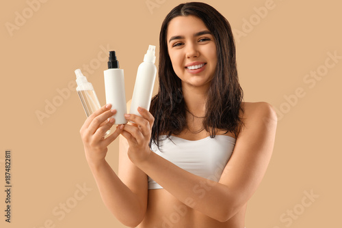 Young woman with hair spray...