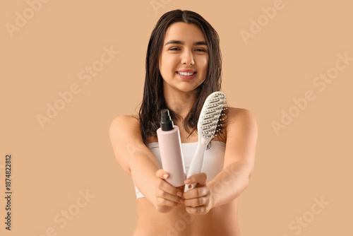 Young woman with hair spray...