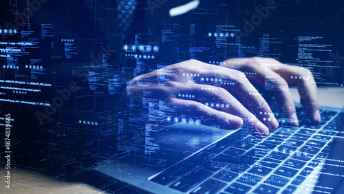 Close-up of programmer typing on laptop with virtual code and digital interface overlay. Ideal for cybersecurity, coding, and software development themes. Technology background concept.