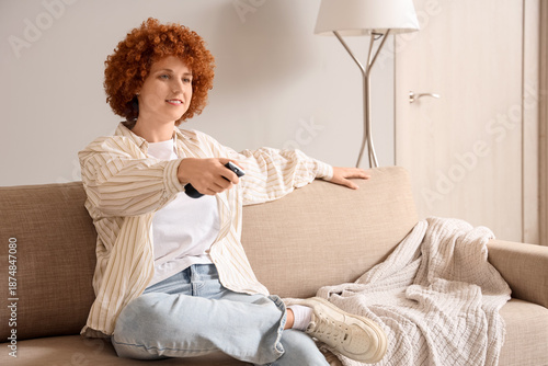 Young redhead woman watchin...