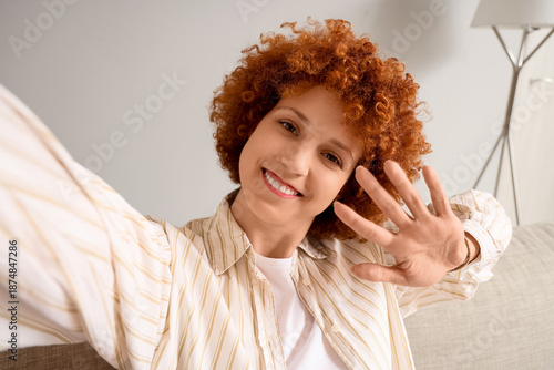 Young redhead woman taking ...
