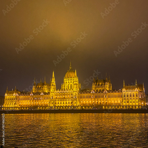 The Hungarian Parliament Building at night with lights and illumination, panorama view over the Danube river on a chilling winter day