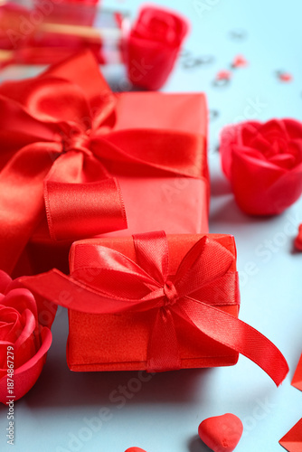 Gift boxes and red roses on blue background. Valentine's Day celebration