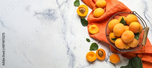 Basket of ripe apricots on light background with space for text © Pixel-Shot