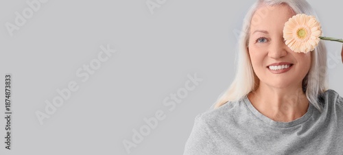 Mature woman with gerbera f...