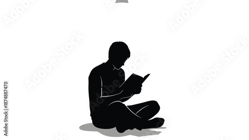 a person sitting cross legged reading a book under a light bulb