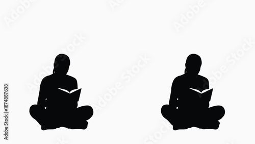 two people sitting in lotus position under spotlight reading