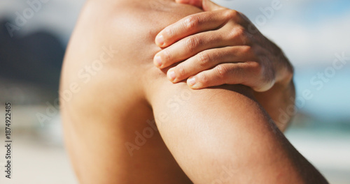 Photos Hand, shoulder and pain at beach with tension, inflammation or stiff joint with fibromyalgia