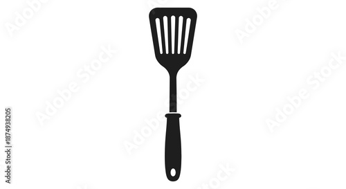 A simple black kitchen utensil a slotted spatula shown in a striking silhouette