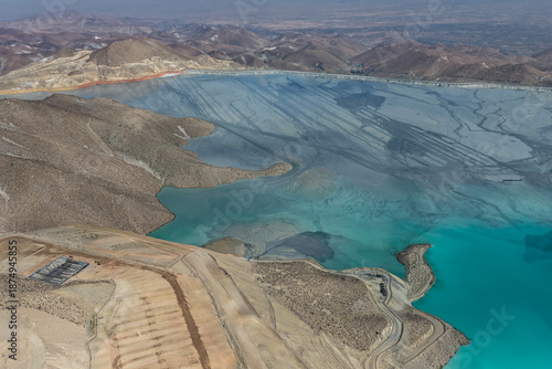 Schilderij op canvas Panoramic view of a mining tailings dam with a huge reservoir in the process of