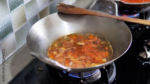 Cooking Vegetables at Home Kitchen with Wooden Spatula