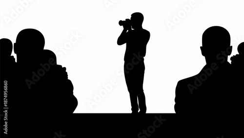 Photographer capturing moments with audience silhouettes