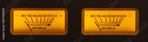 Audio Dual Volume Unit Meters Glowing in the Dark with Yellow and Orange Hues.