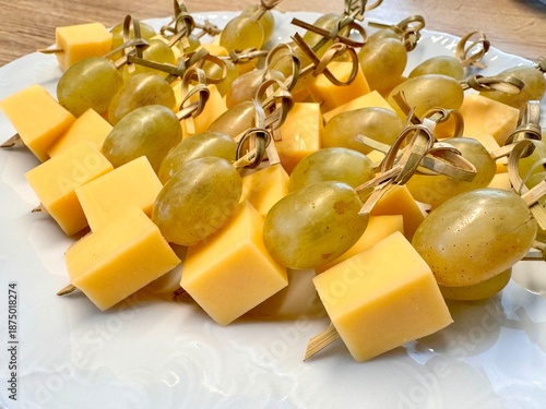 New Year's snack skewers hard cheese with grapes on the festive table