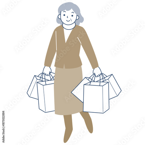 多数のショッピングバッグを持って歩くシニア女性