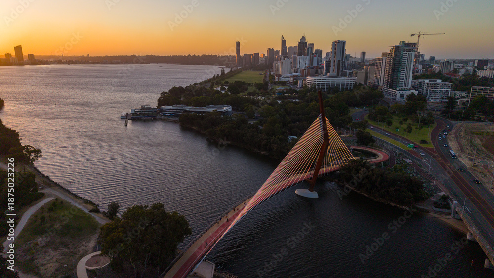 Naklejka premium Aerial view of Perth city skyline with Boorloo bridge lit up connecting Heirisson island with walking and cycling path along the Swan river
