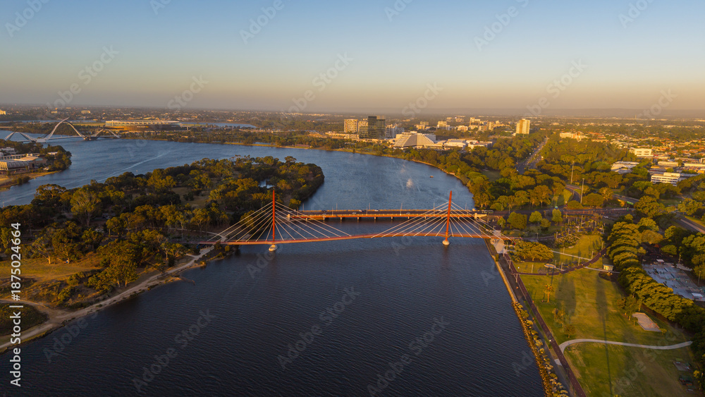 Naklejka premium Aerial view of Perth city skyline with Boorloo bridge lit up connecting Heirisson island with walking and cycling path along the Swan river