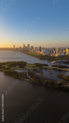 Aerial view of Perth city skyline with Boorloo bridge lit up connecting Heirisson island with walking and cycling path along the Swan river