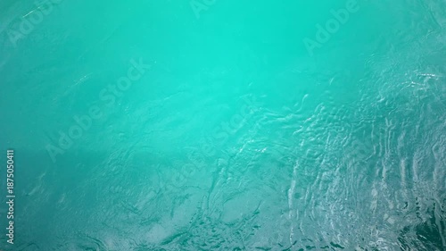 Clear turquoise lake water surface with gentle ripples