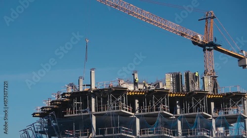 Construction of a building. Construction site with crane. Business, development, industry.