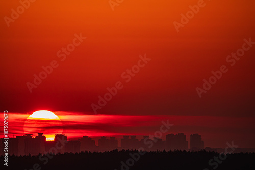 Sunset casts a warm glow over the city, silhouetting the buildings against a colorful sky