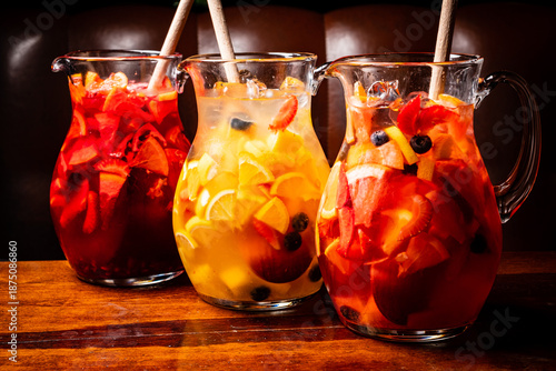 Φωτογραφία Colorful jugs of fruit punch filled with fresh fruit sit invitingly on a rustic