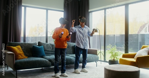 Mother and son in virtual reality headsets playing video game at home