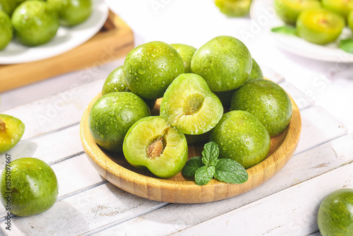 Fresh Green Plums with Pit on Wooden Bowl - Healthy Fruit